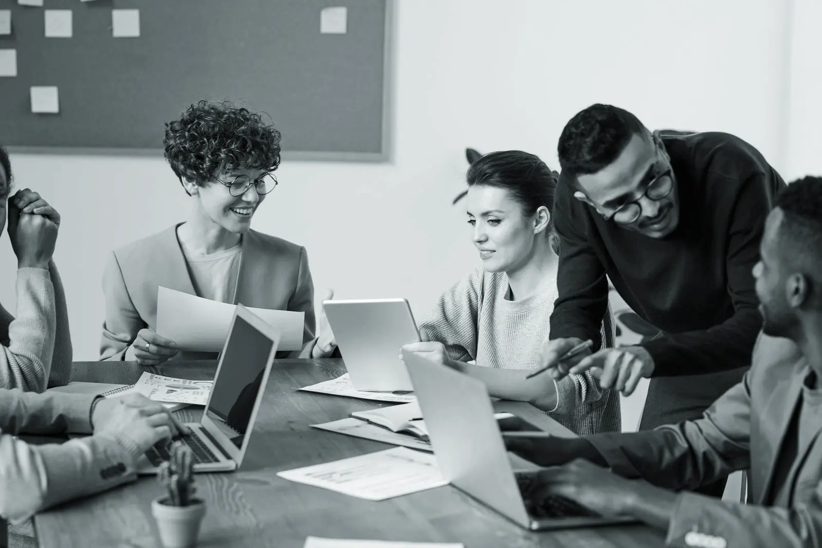 A facilitator working through ideas with a diverse team around a table