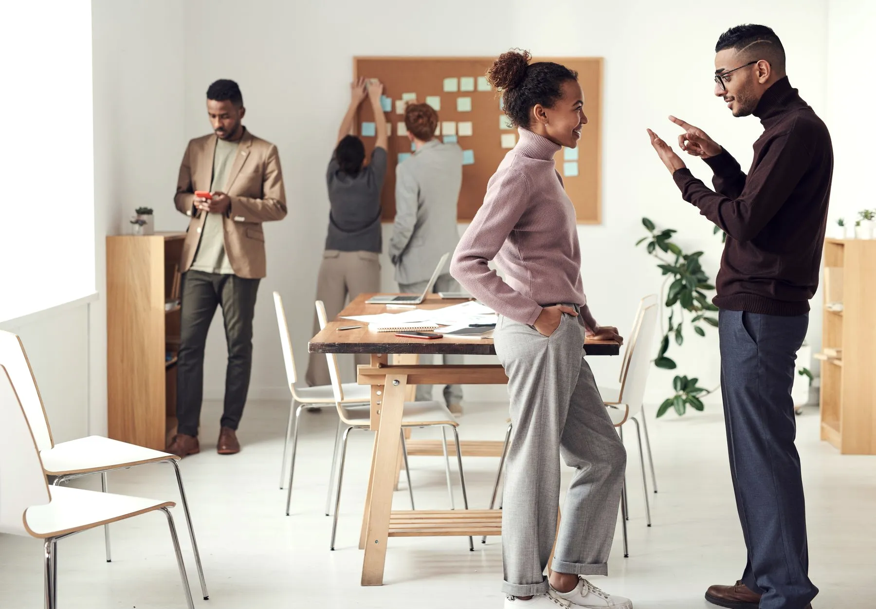 A diverse team collaborating and smiling in a bright modern office